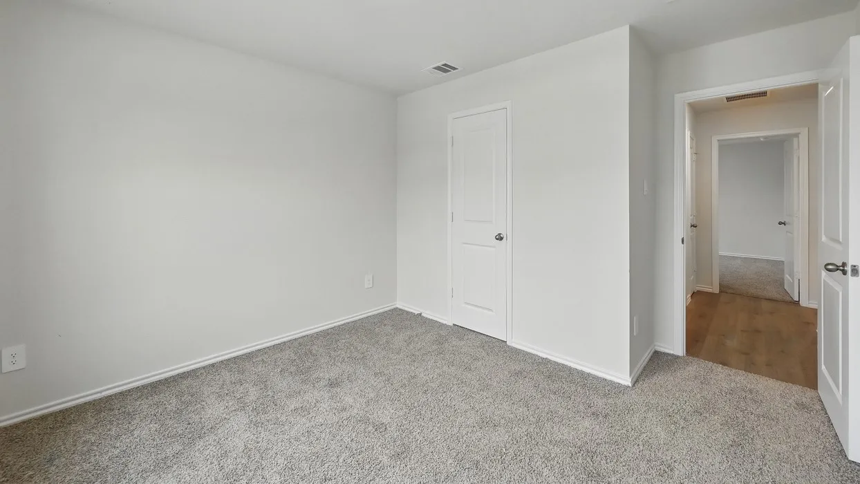 Light gray carpeting, white walls, and white trim