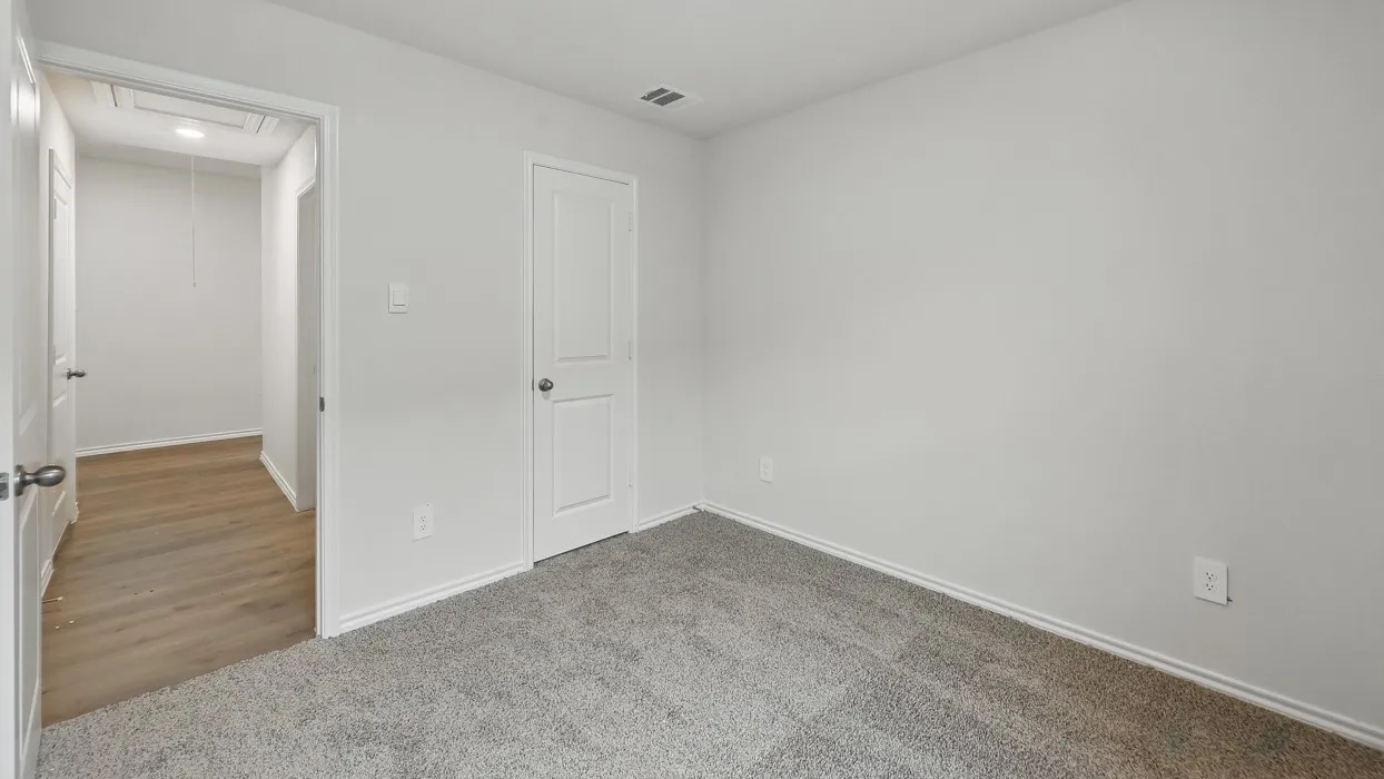 Light gray carpeting, white walls, and white trim