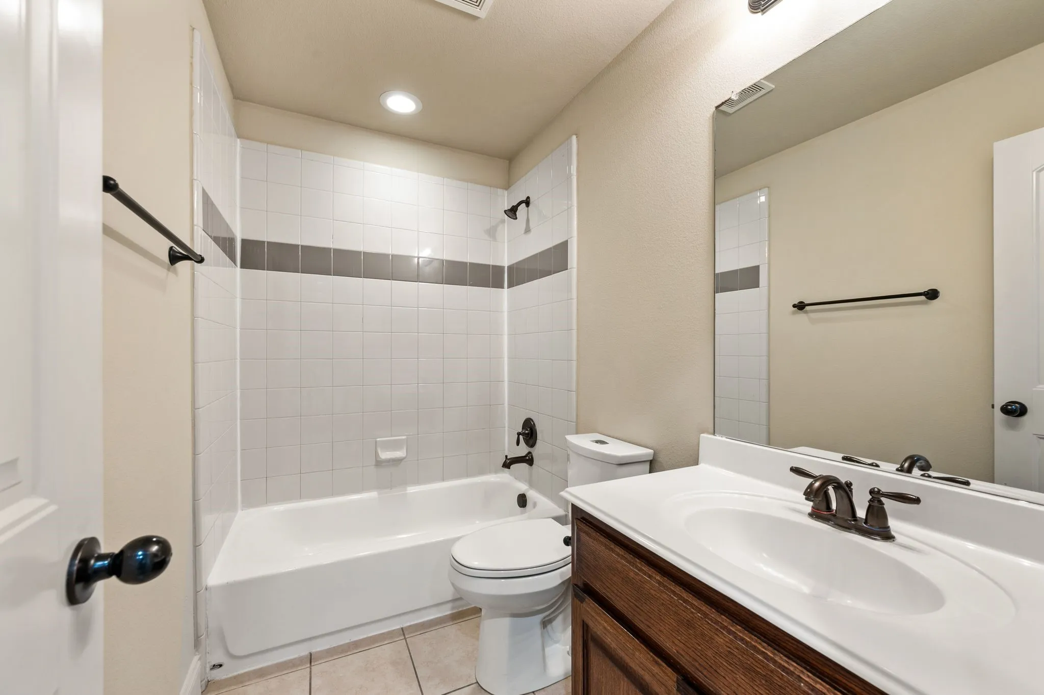 Bathroom featuring a vanity with dark wood-finish cabinetry, a white countertop, and a white integrated sink