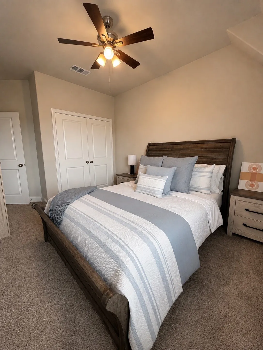 Carpeted flooring, vaulted ceiling, and a ceiling fan with integrated lighting