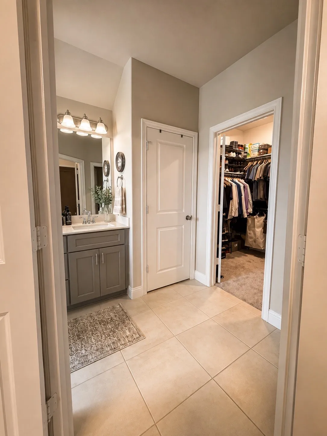 Tile flooring throughout, vanity with undermount sink, built-in shelving, and recessed lighting