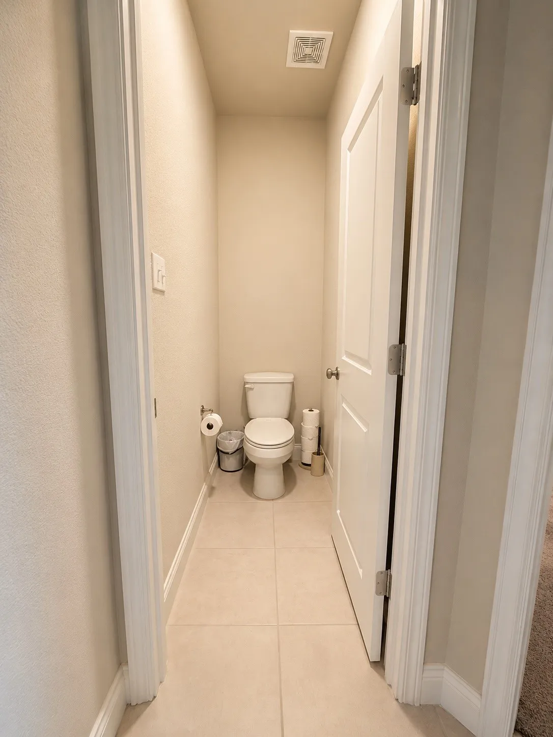 Tile flooring with a white toilet and light-colored walls