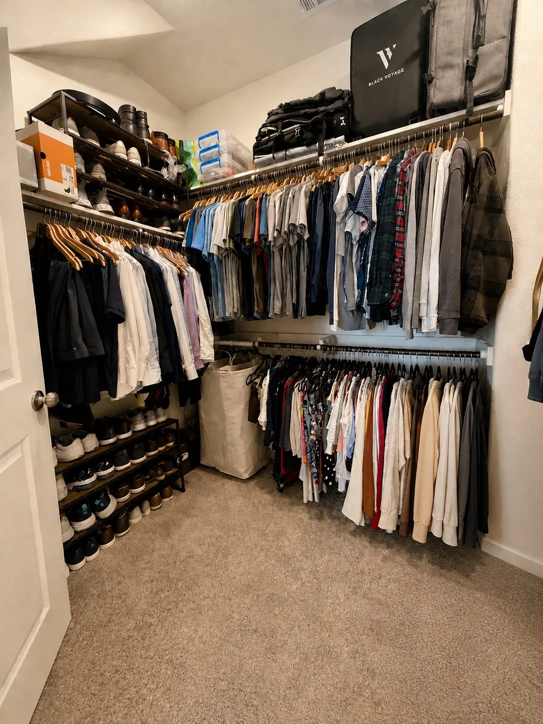 Built-in closet organization system featuring multiple hanging rods, overhead shelving, and integrated shoe racks