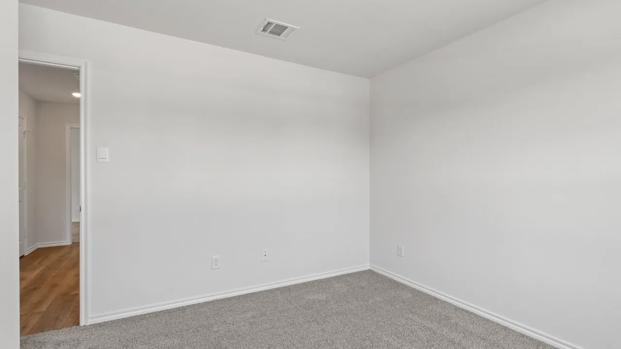 Room featuring light gray carpeting, white painted walls, and white baseboards