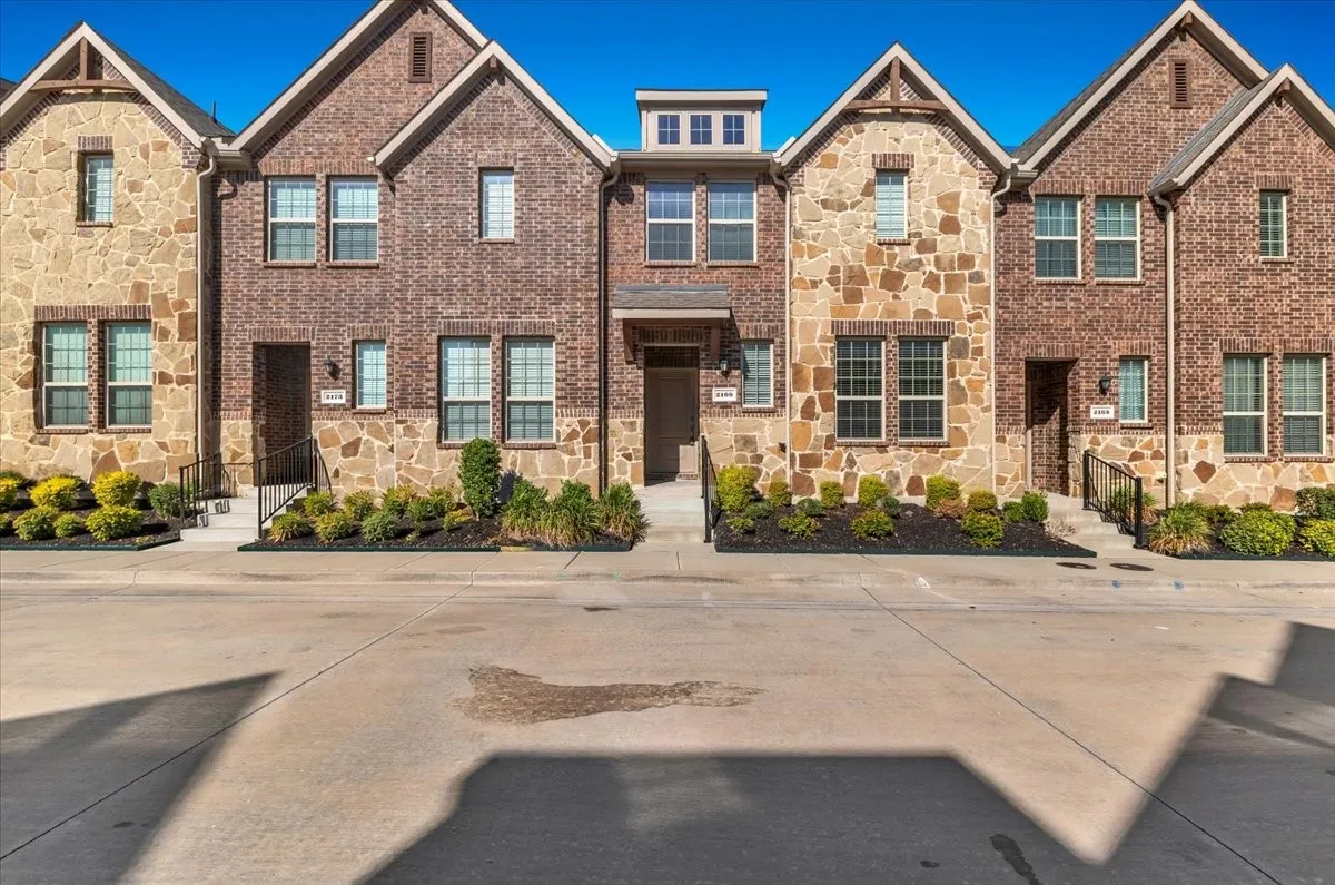 Brick and stone facade with multiple window configurations