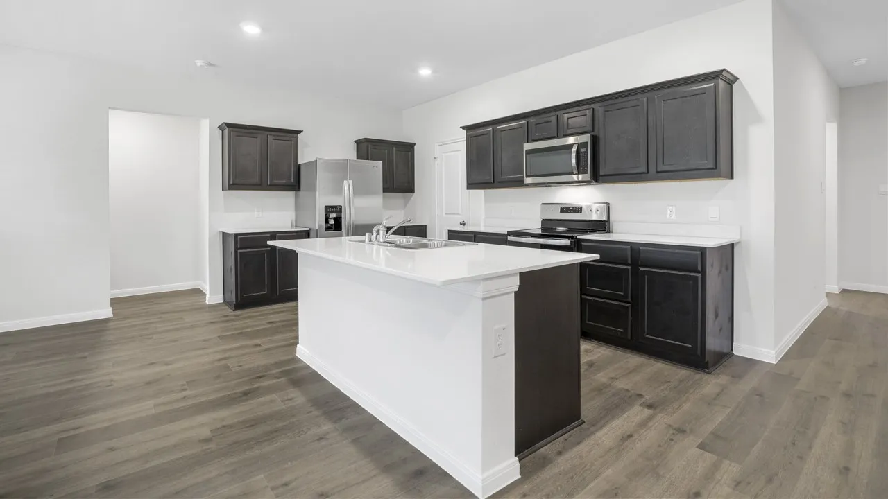 Kitchen featuring an expansive island with a white countertop, dark wood-finish cabinetry, stainless steel appliances, white subway tile backsplash, and wood-finish flooring