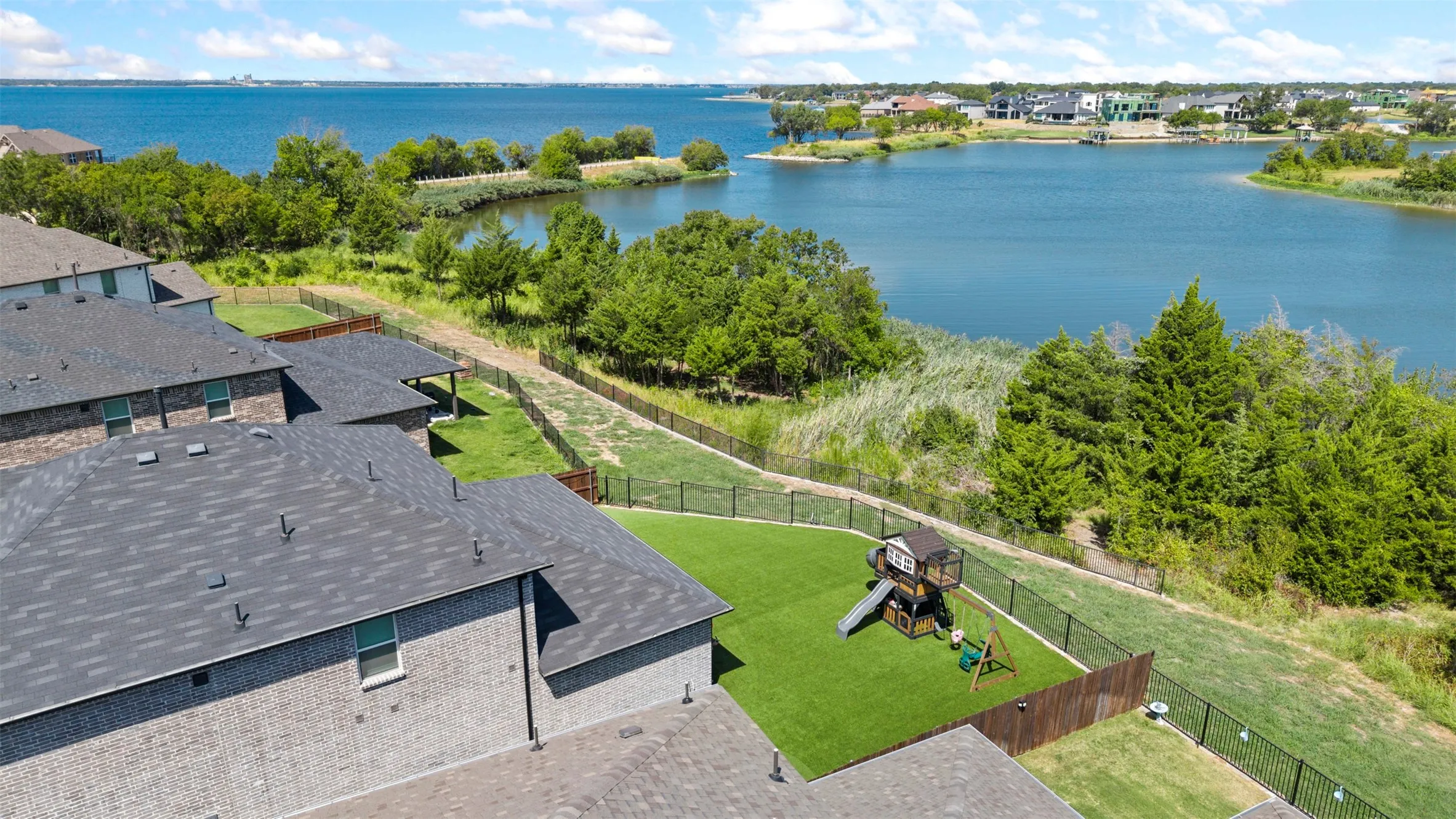 Backyard facing the water with Play Set