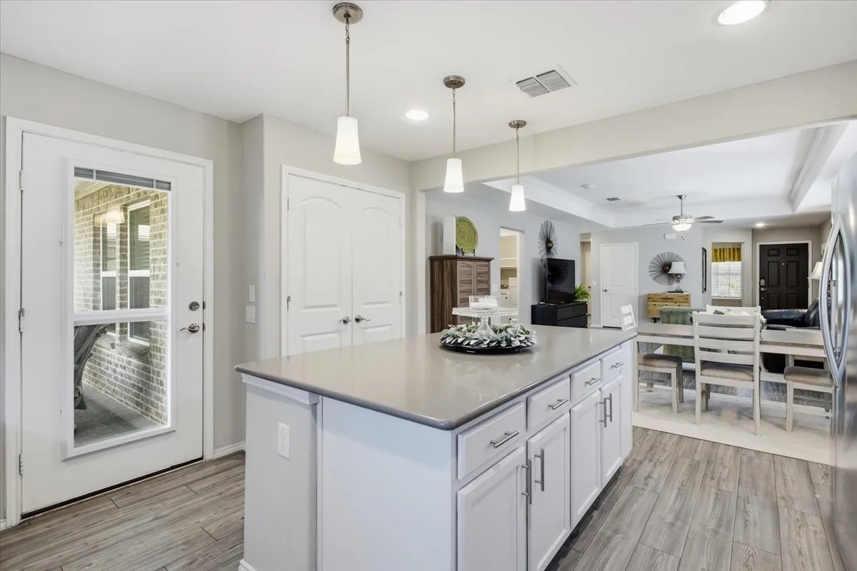 The kitchen features a large island with extra storage space.