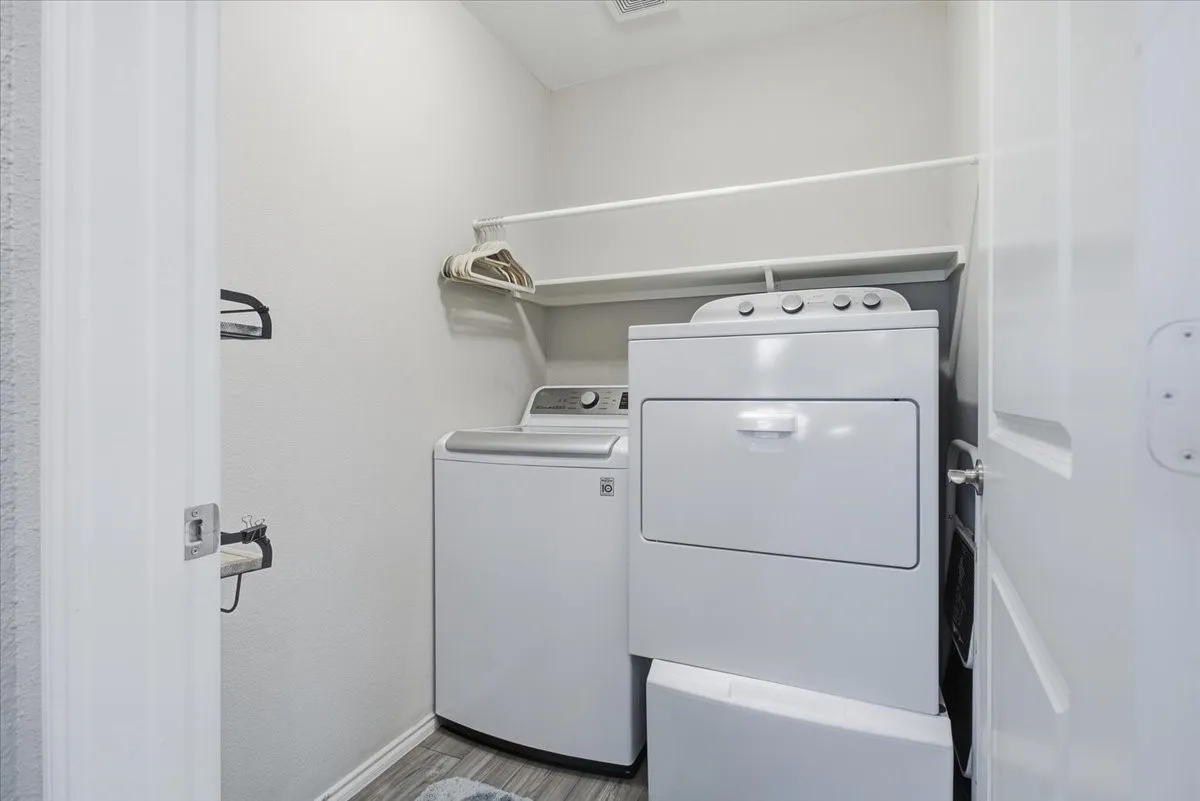 Separate utility room across the hall from the primary bedroom