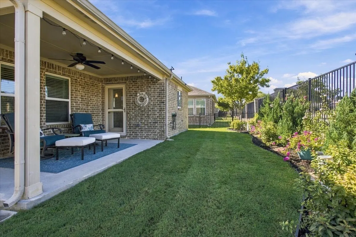 The covered patio looks over beautiful landscaping and no neighbors behind you.