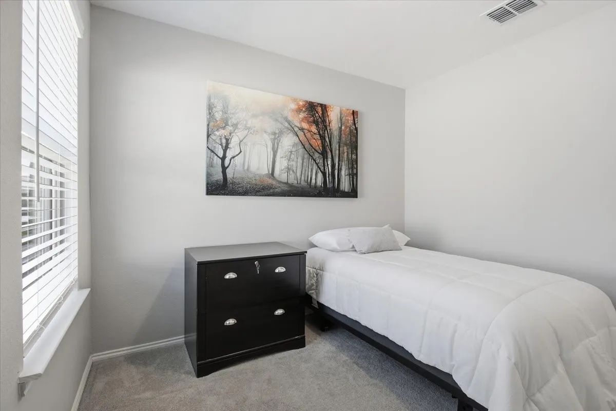 The secondary bedroom is a great size with a ceiling fan and closet