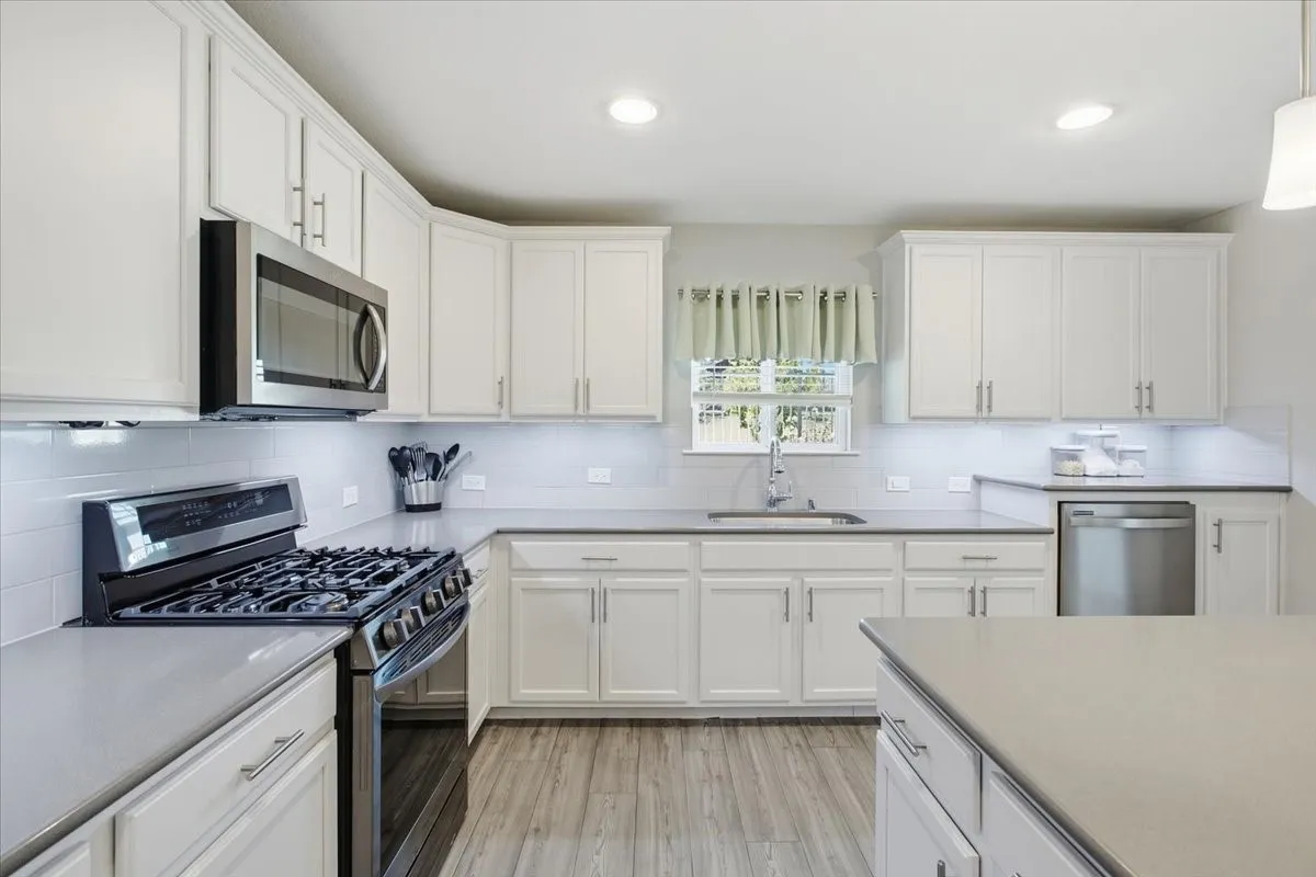 So much storage! Also the dishwasher is raised and a cute window above the sink.