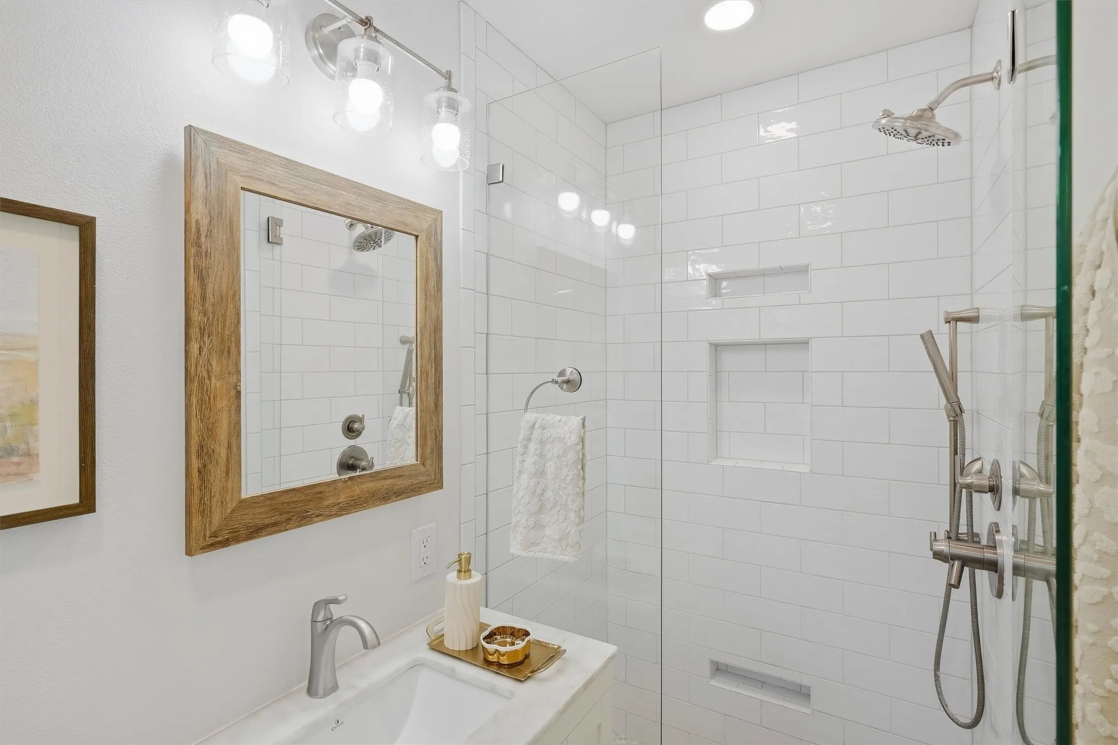 Highligting a beautiful frameless, glass enclosed walk in shower.