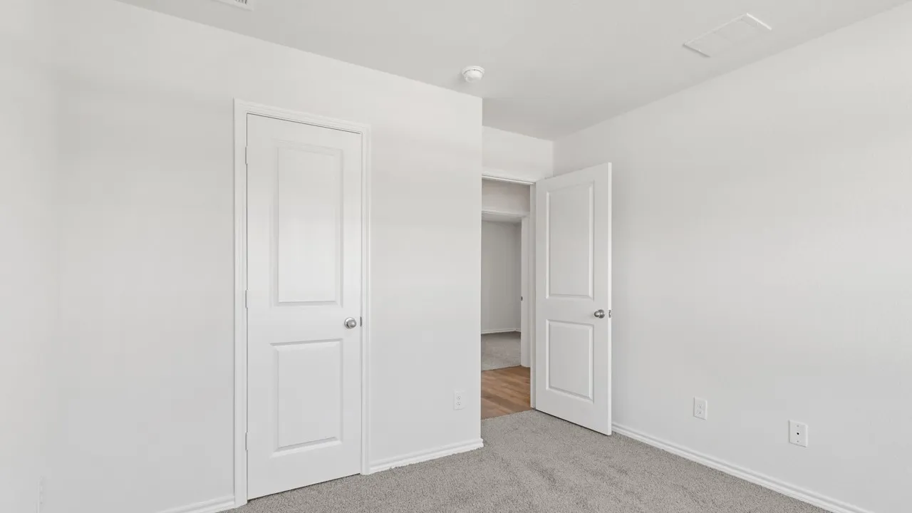 Neutral wall tones with textured finishes, crisp white trim, light gray carpet, and white paneled doors