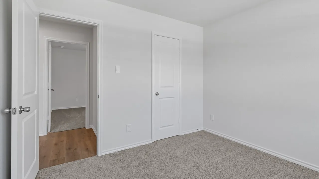 Bedroom featuring light gray carpet flooring and white painted walls