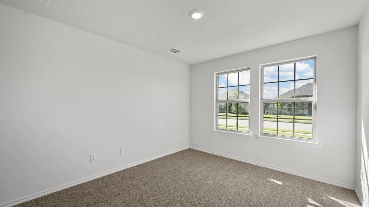 Neutral-toned carpeting paired with white walls, baseboards, and trim