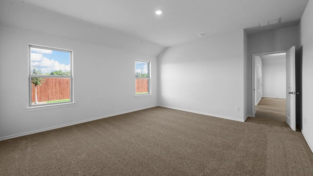 Spacious room featuring neutral carpeting and white walls