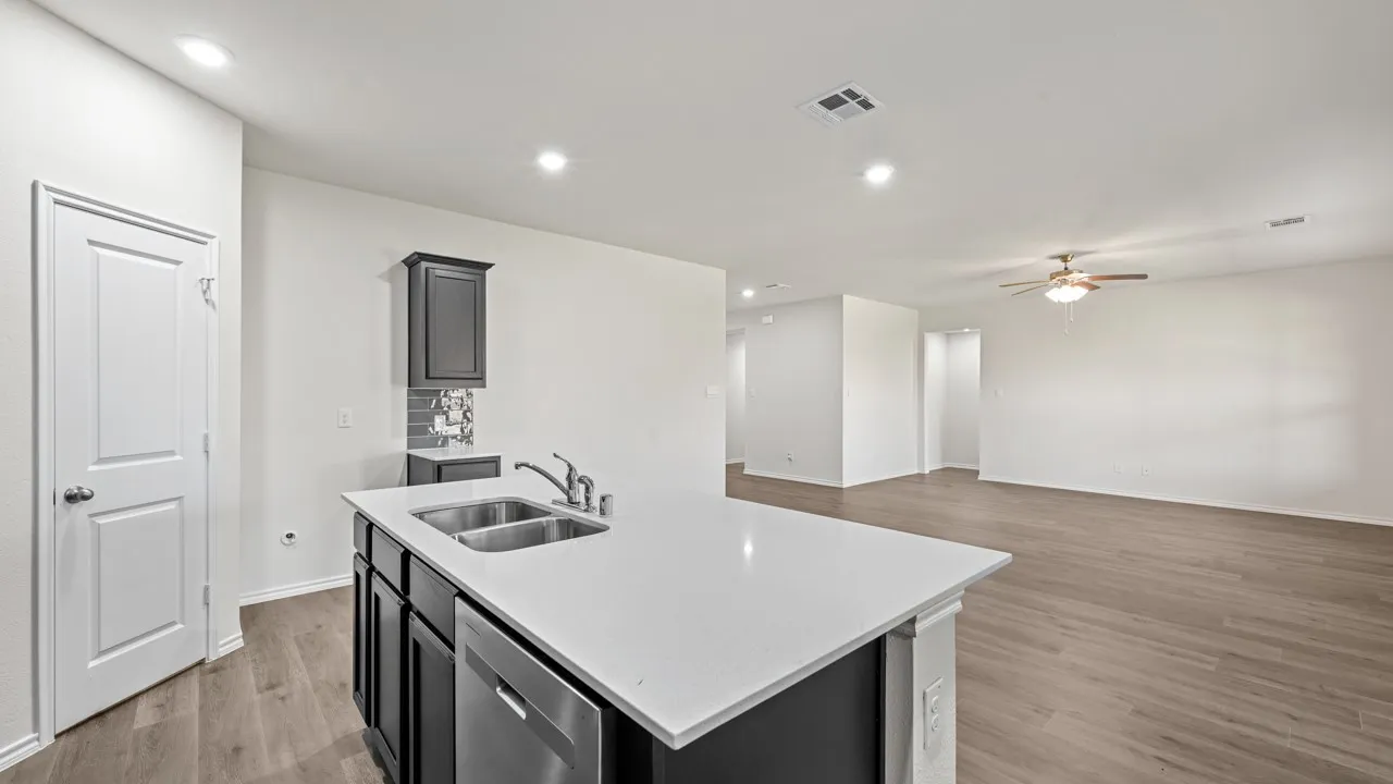 Kitchen island with a double basin sink, stainless steel faucet, and dishwasher