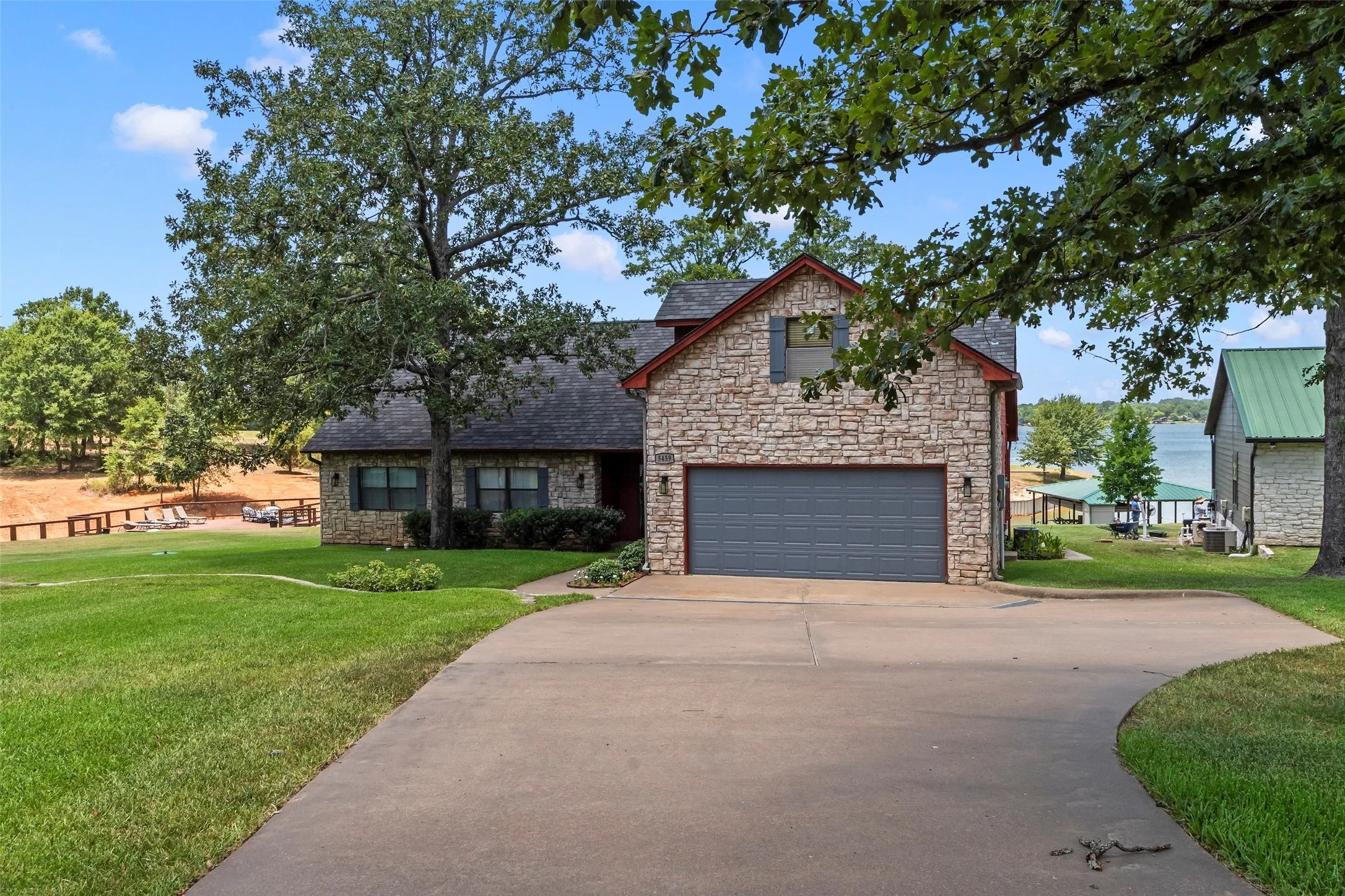 Inviting stone and wood exterior with mature trees and expansive front yard. Two car attached garage plus long driveway for ample parking.