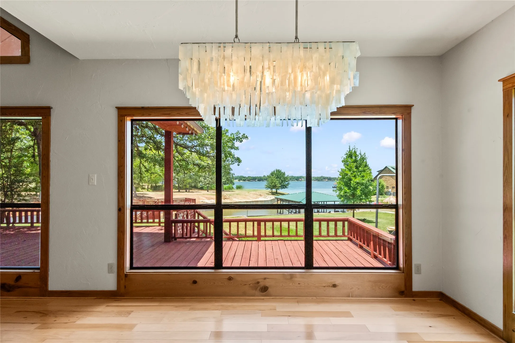 Lovely dining area with large windows showcasing open water views.