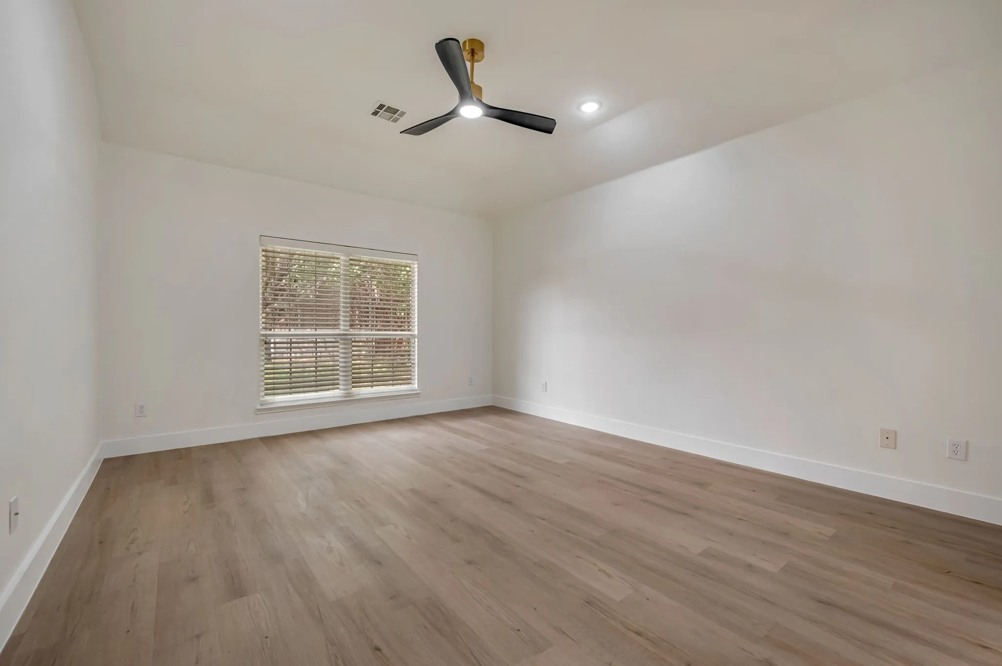 Vaulted ceiling featuring a contemporary ceiling fan and recessed lighting