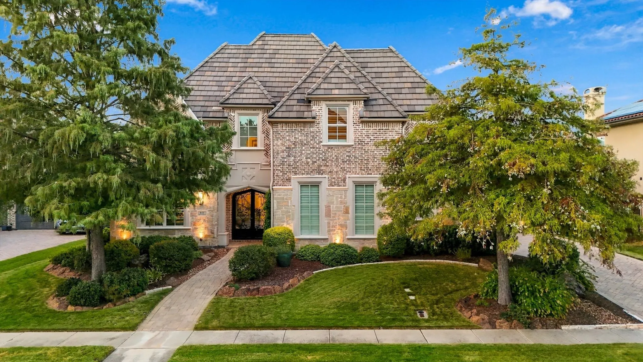 Luxury custom home in the gated and guarded community of Lakes of Las Colinas. 50 year concrete tile roof and pavestone walkway and oversized driveway with 3 car garage