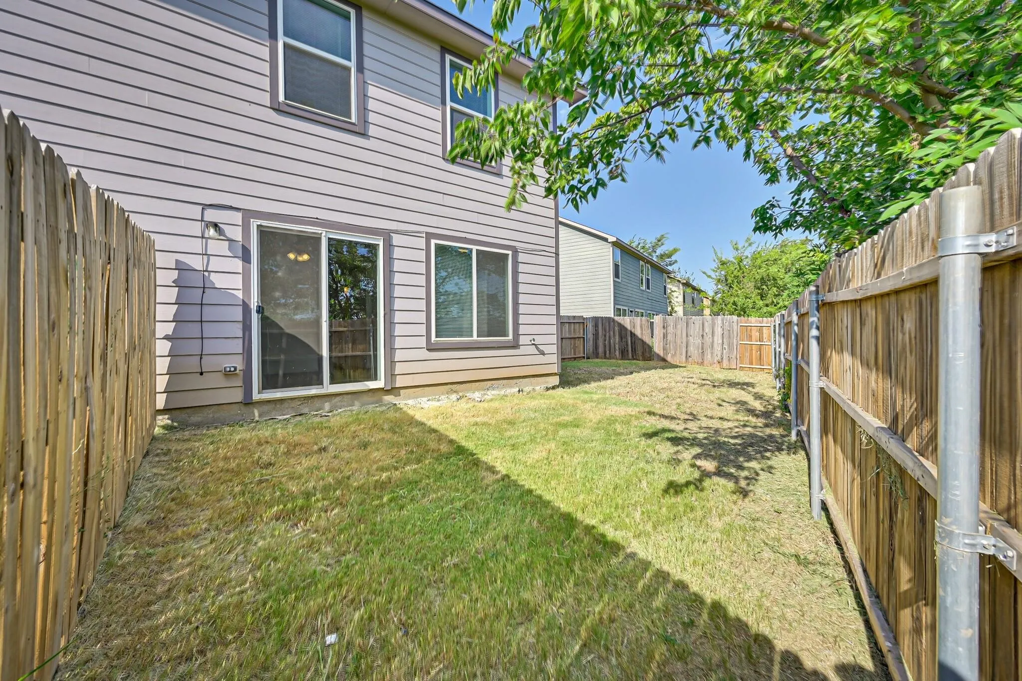 View of fenced backyard