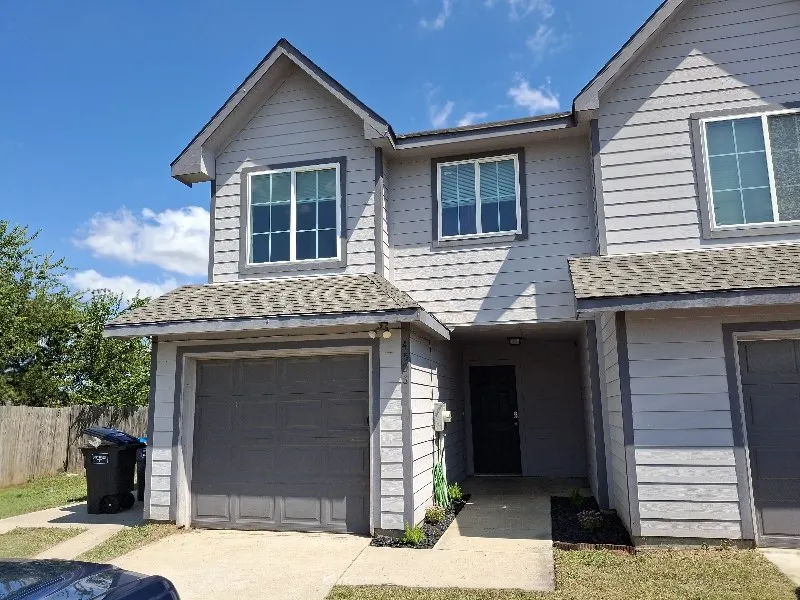 View of front of house featuring roof with shingles and an attached garage
