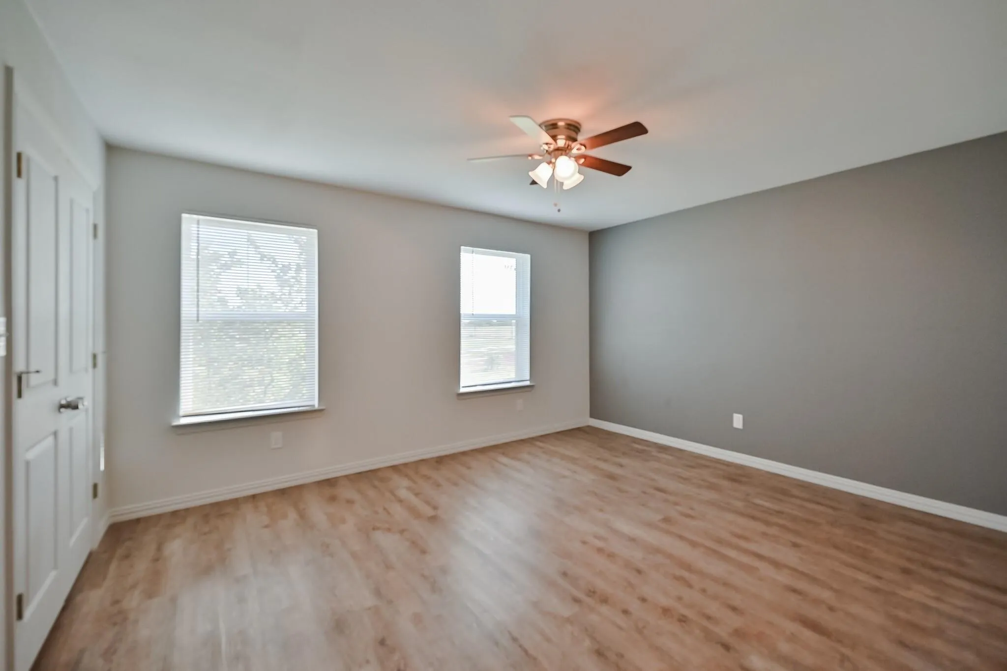 Spare room featuring light wood finished floors and ceiling fan