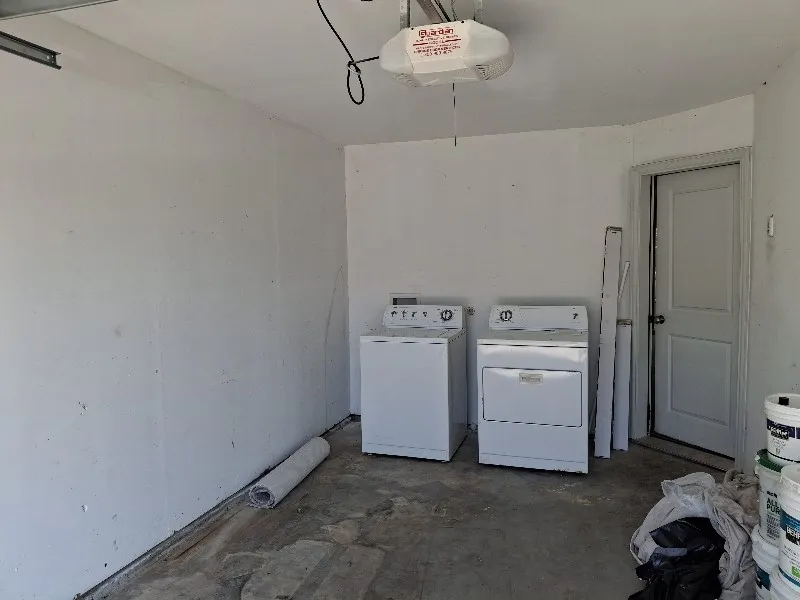 Washroom with washing machine and clothes dryer