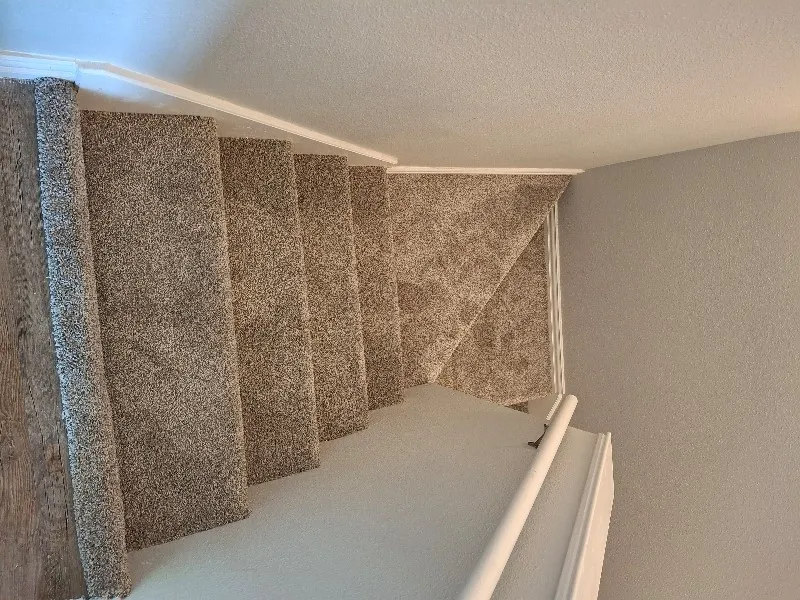 Staircase featuring a textured ceiling