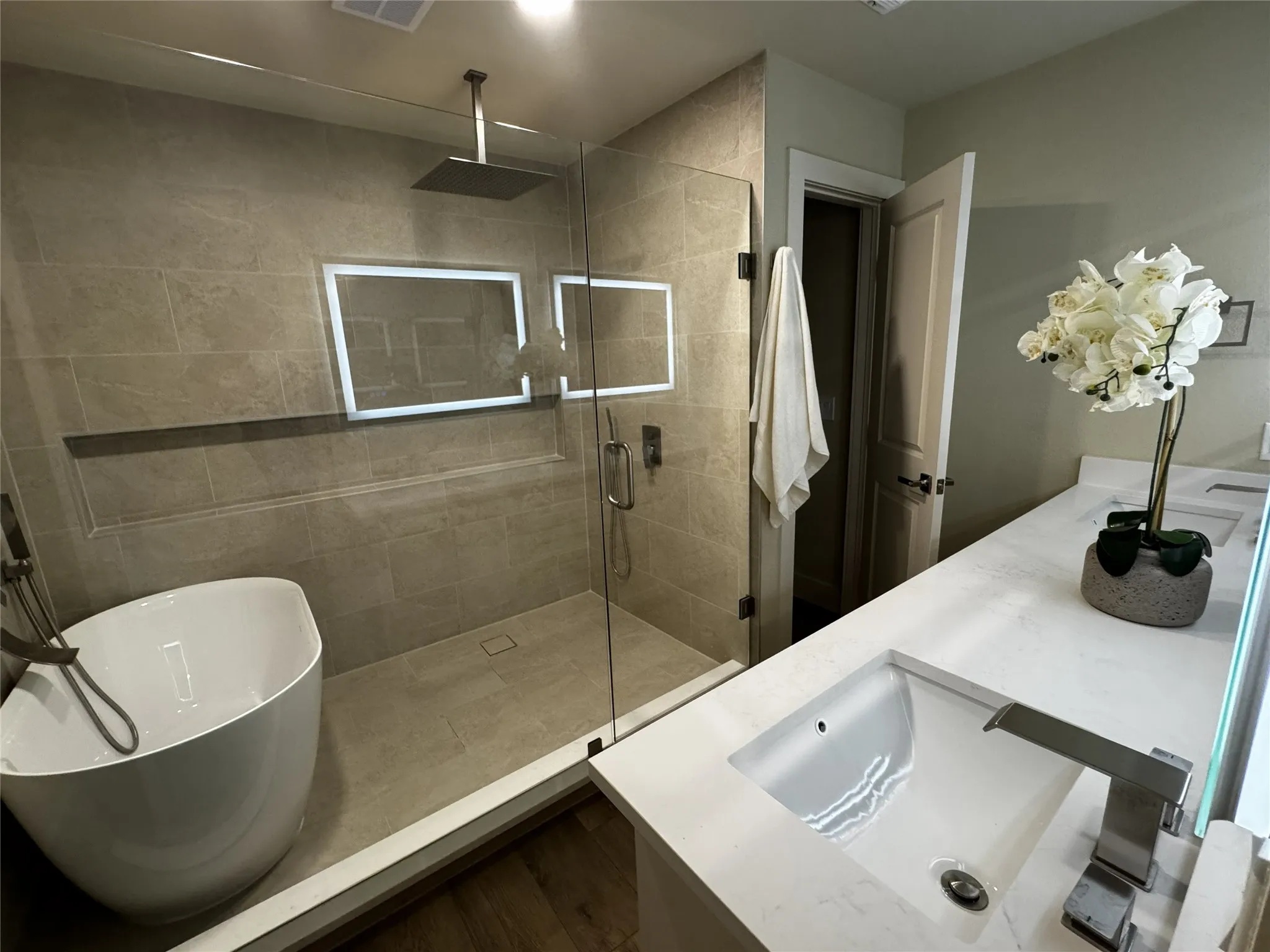 Dual vanity with integrated sinks, brushed chrome faucets, and white countertops