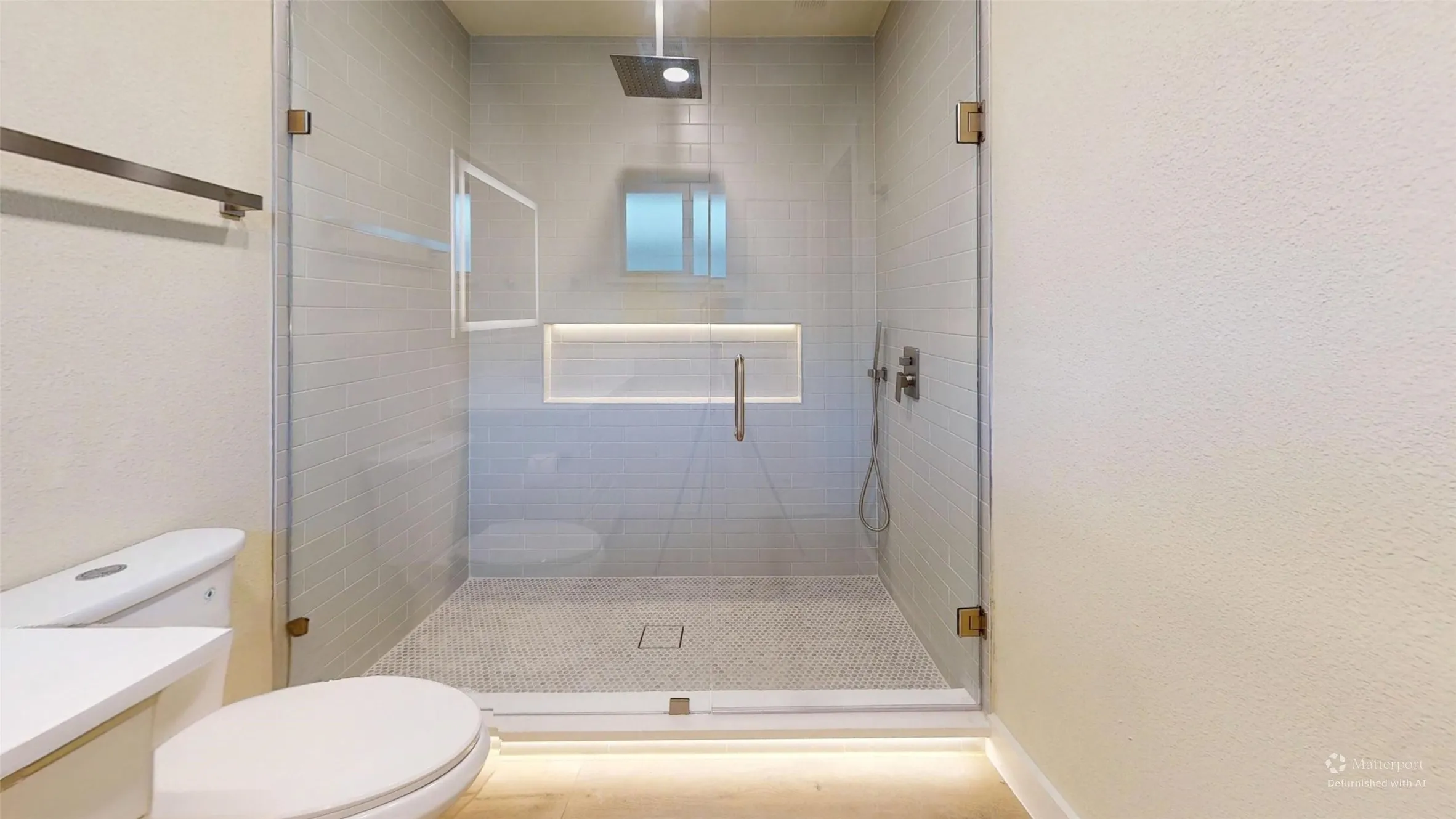 Glass-enclosed shower in 2nd primary with a rainfall showerhead, tiled walls, a built-in niche with accent lighting, and a mosaic​​‌​​​​‌​​‌‌​‌‌​​​‌‌​‌​‌​‌​​​‌​​ floor