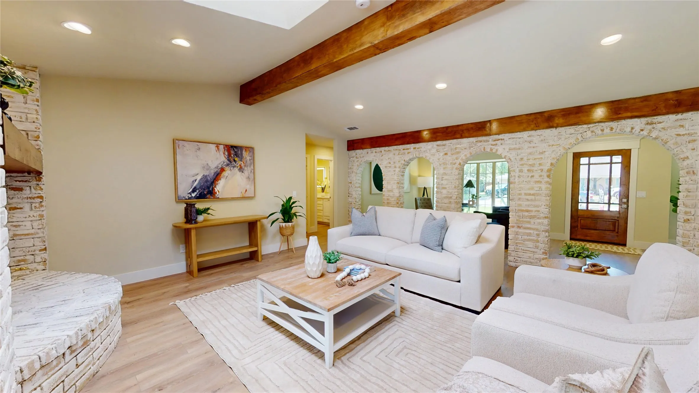 Vaulted ceiling, exposed wood beams, wood-finish flooring, recessed lighting, and German Schmear  brick arches