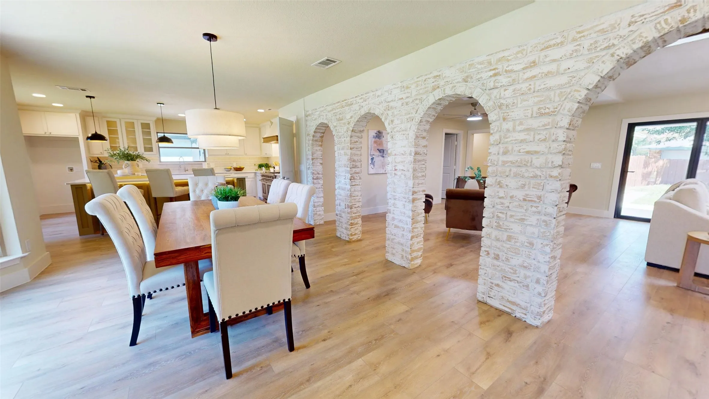Wood-finish flooring throughout, complemented by a German Schmear  brick archway