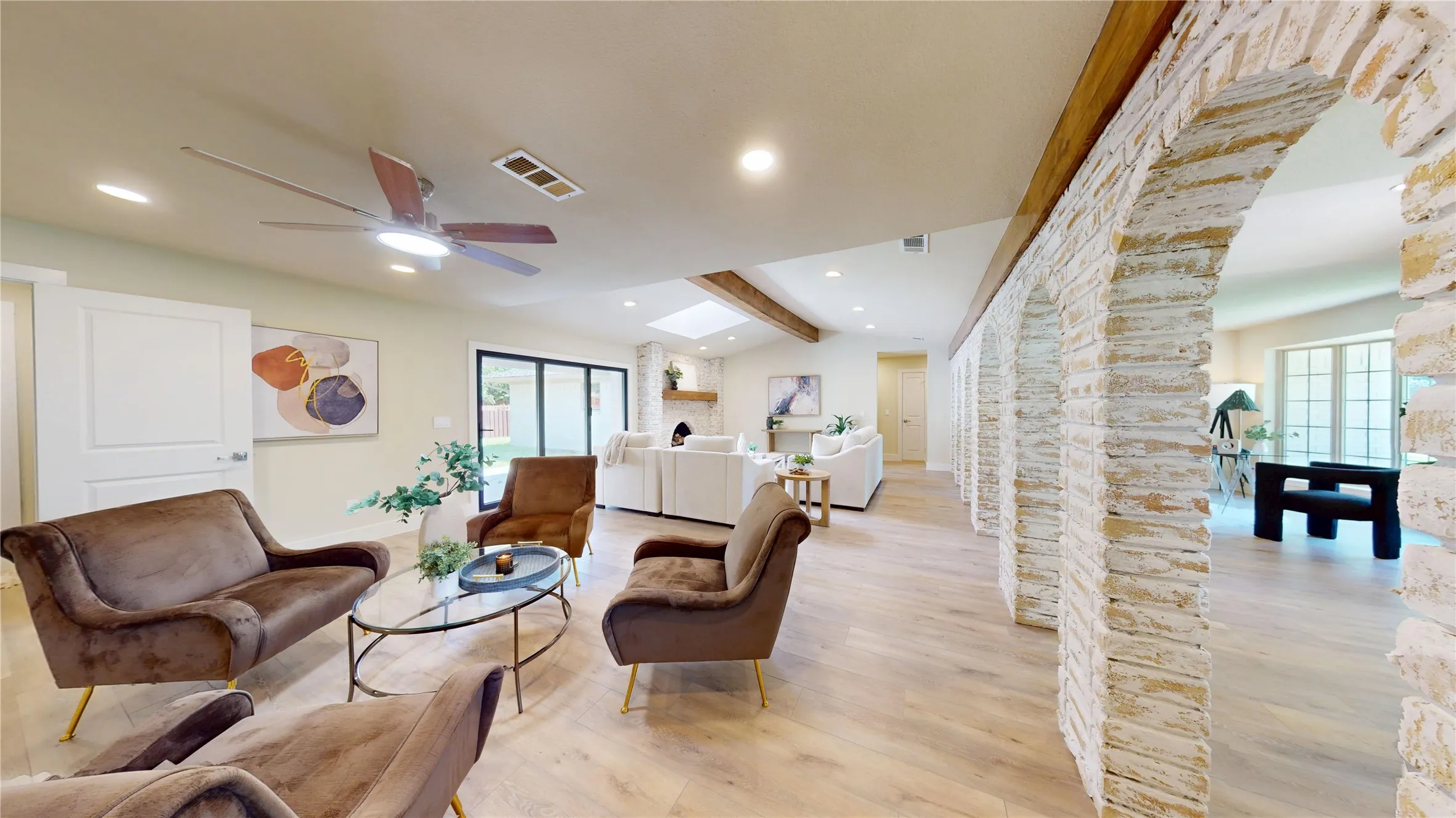 Wood-finish flooring, exposed wood beams, German Schmear  brick archways, recessed lighting, and a modern ceiling fan