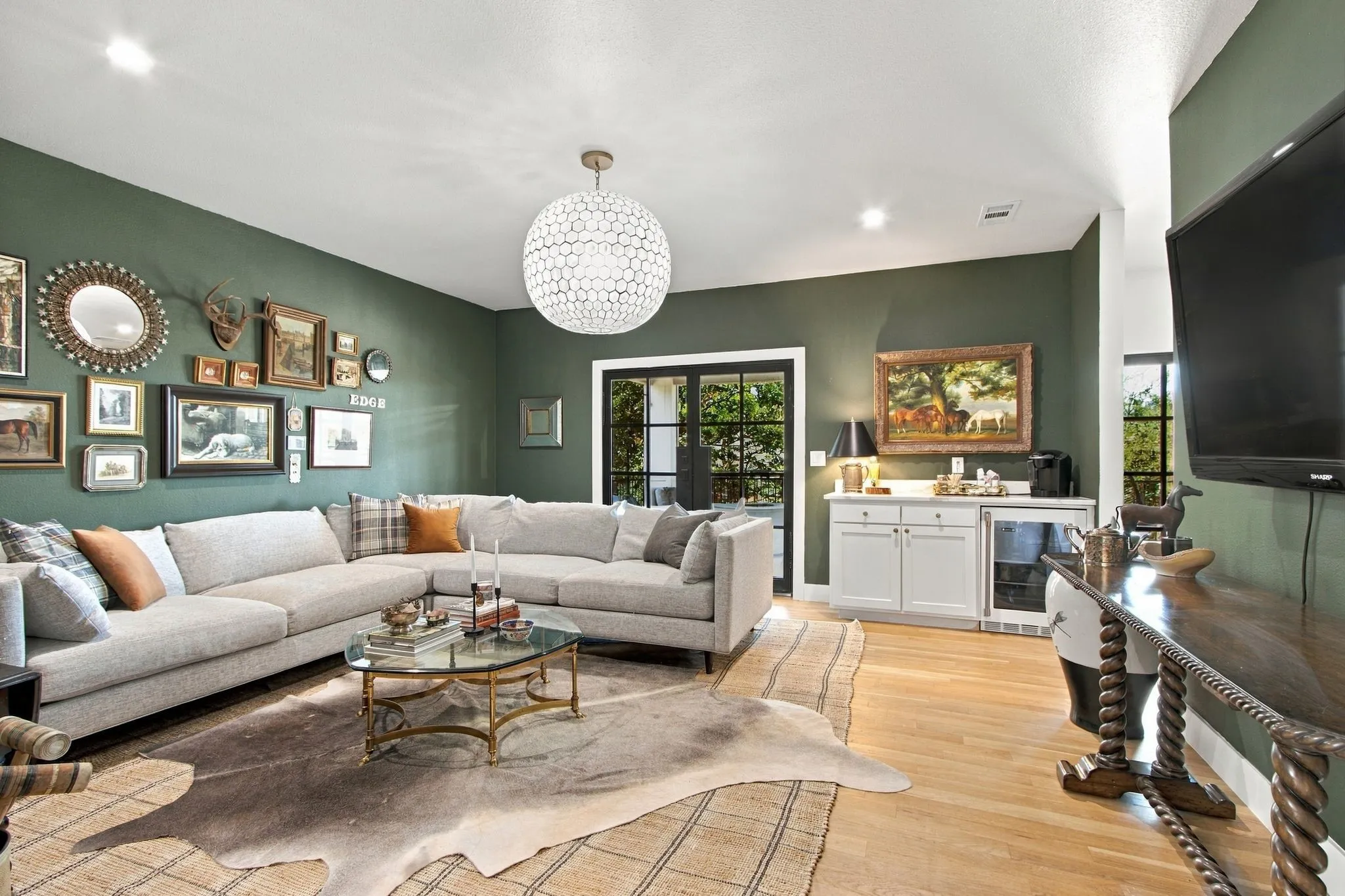 Recessed lighting, wood-finish flooring, and a decorative ceiling fixture illuminate the space