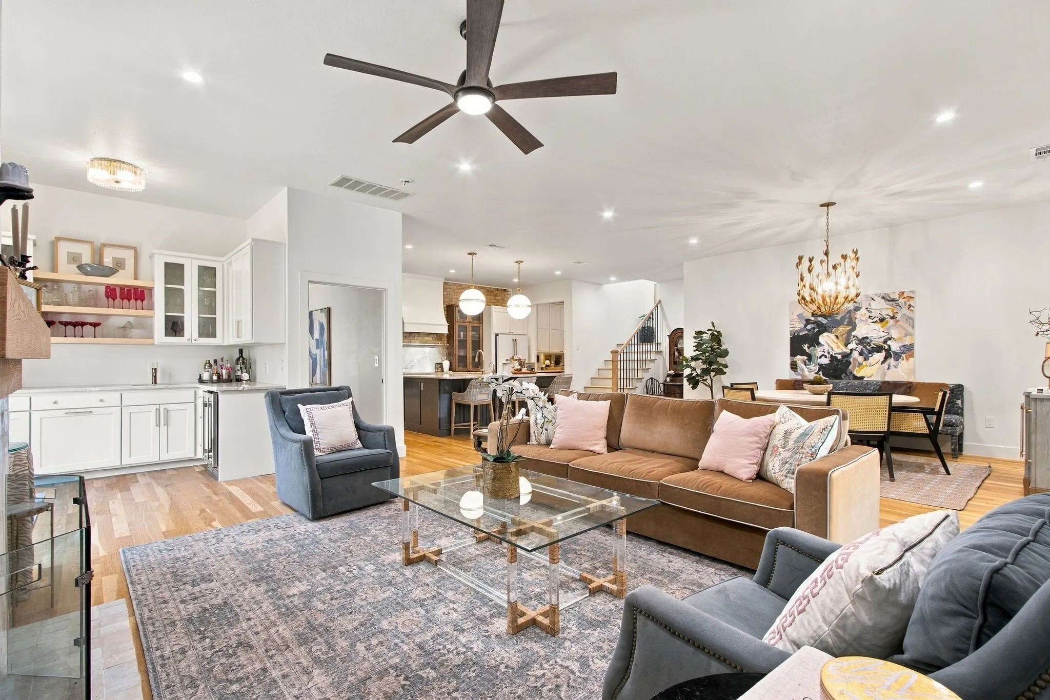Recessed lighting, wood-finish flooring, and a contemporary ceiling fan