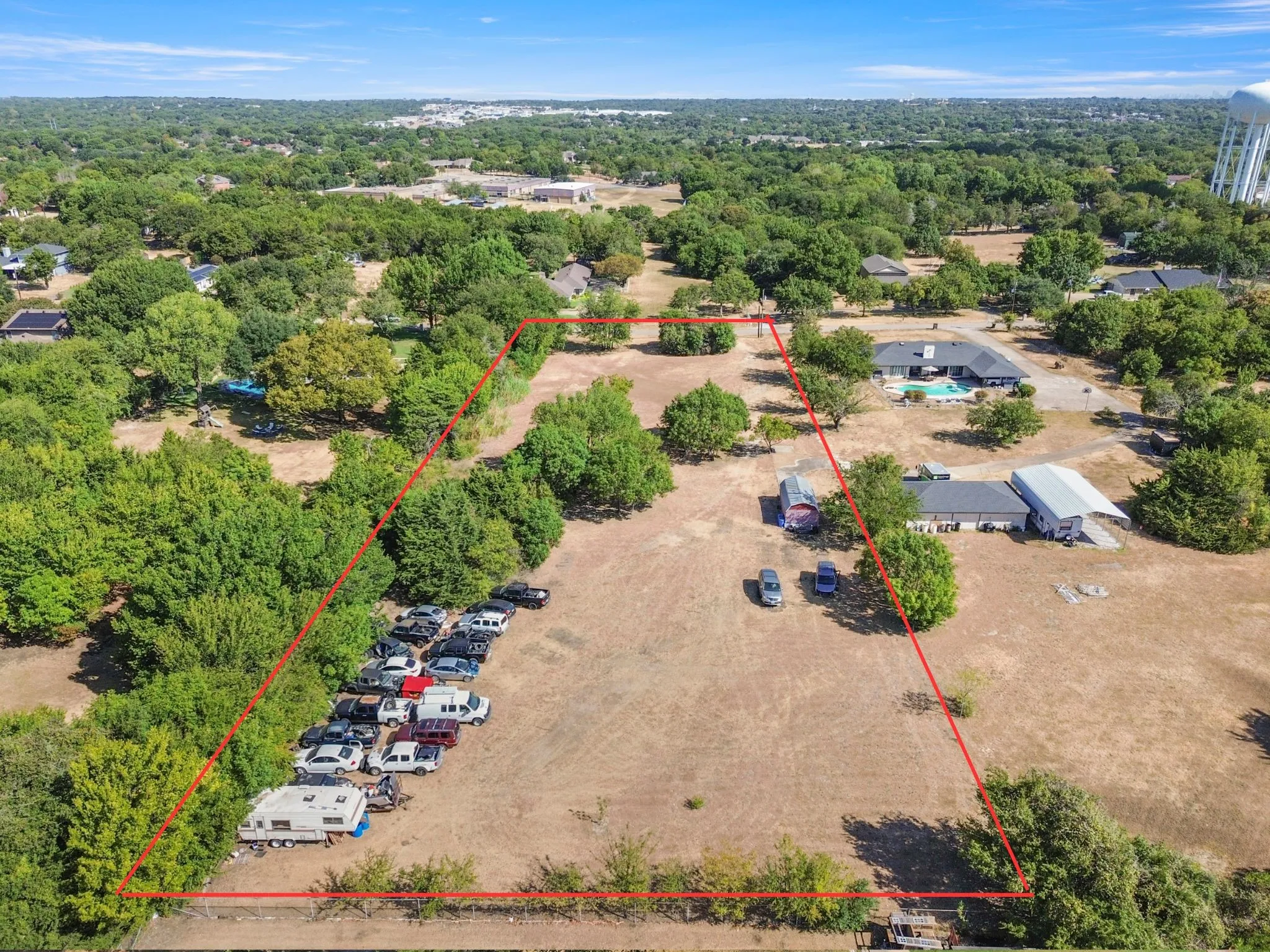 Expansive land parcel featuring open terrain and mature trees
