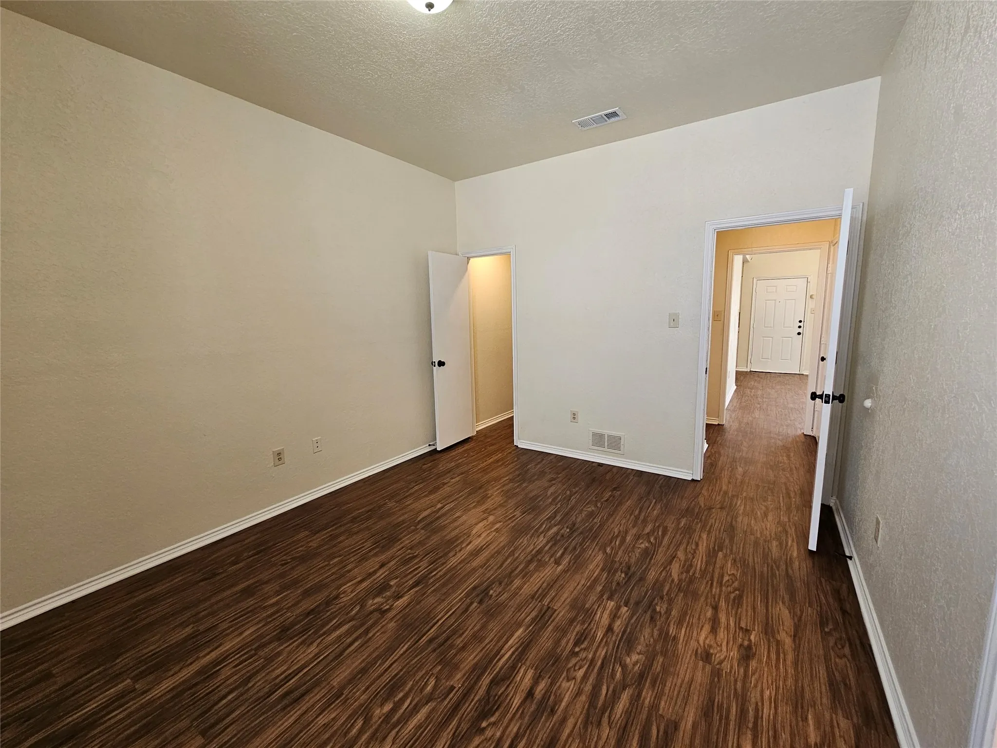 Wood-finish flooring throughout, smooth walls, and ceiling-mounted lighting