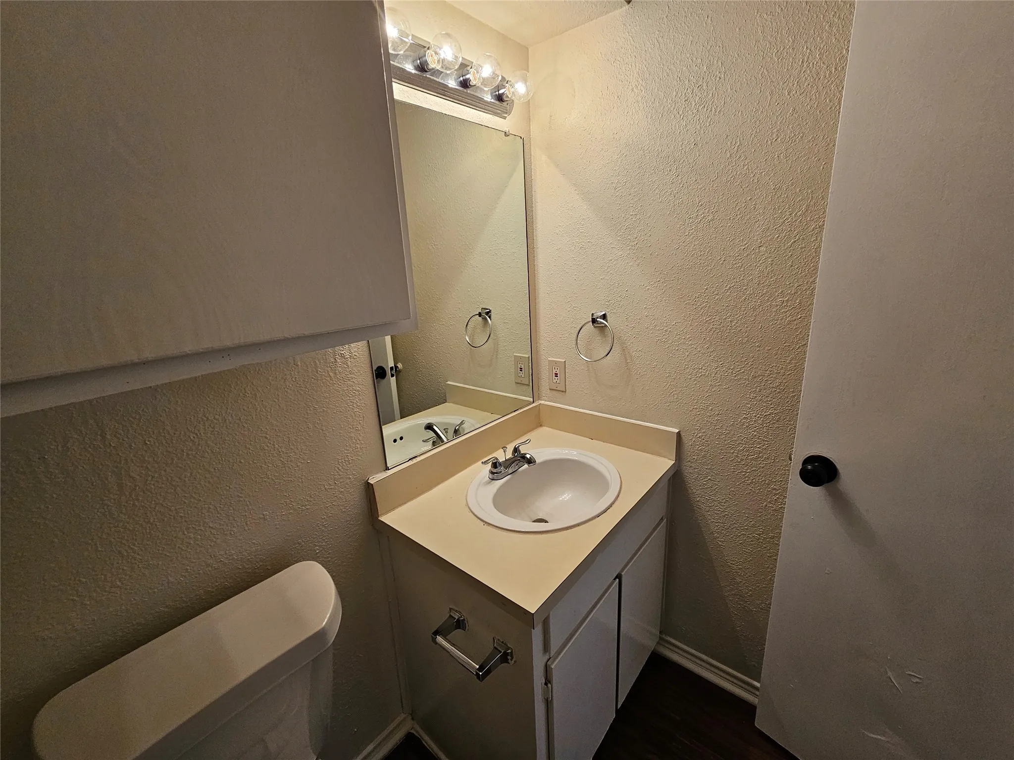 Vanity with integrated sink, chrome faucet, and under-cabinet storage