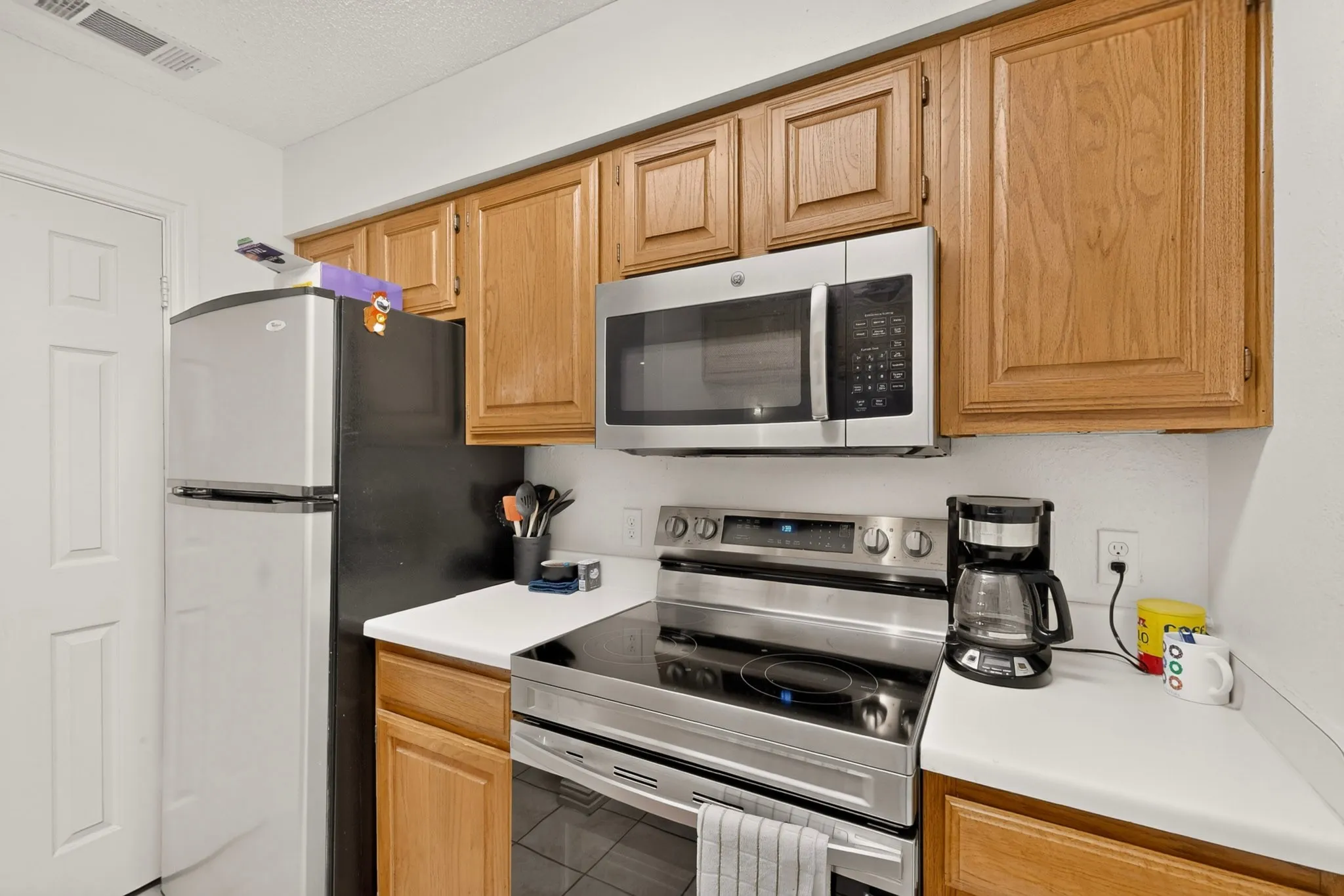 Wood-finish cabinetry paired with white countertops