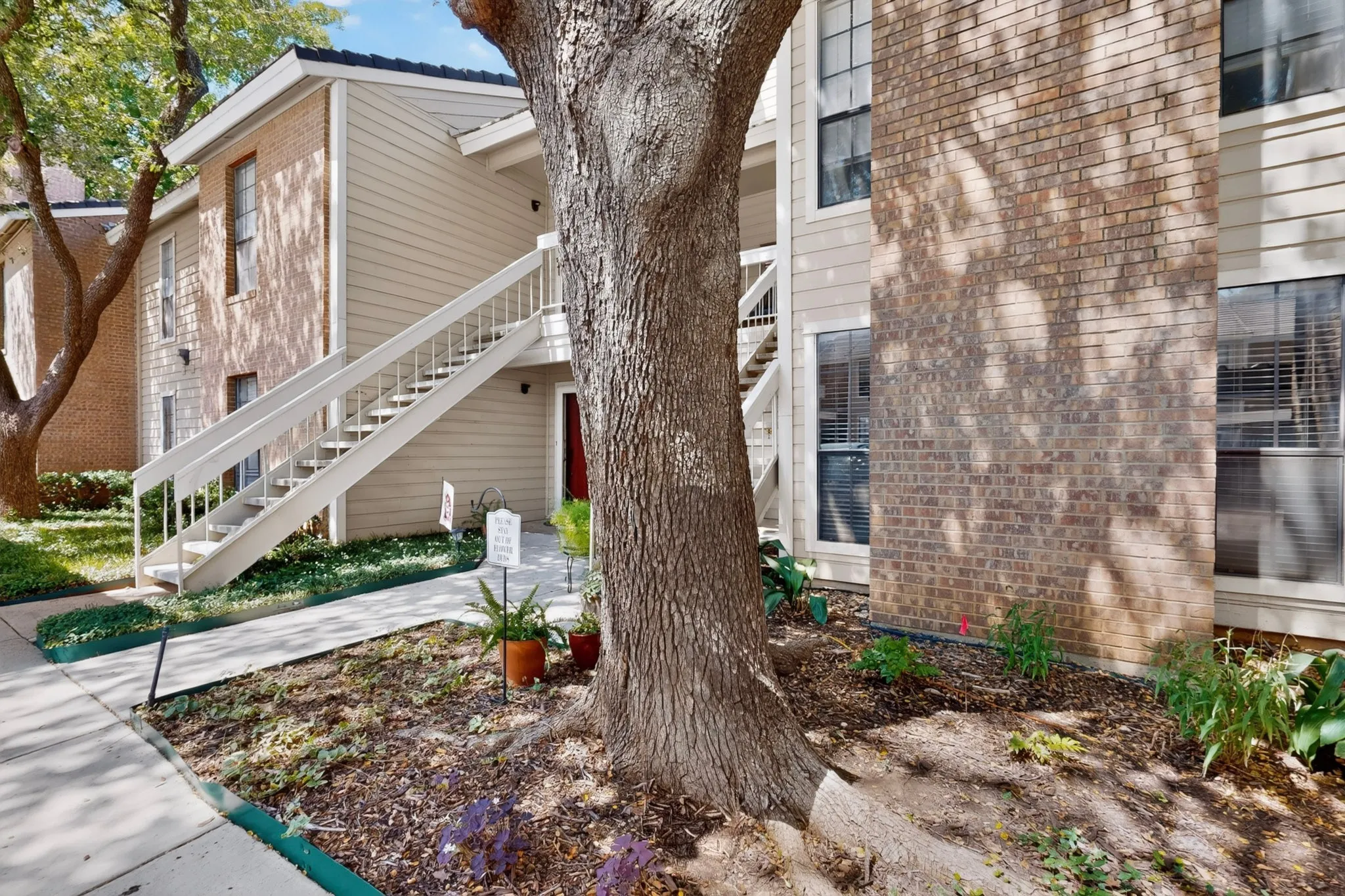 Brick and siding exterior with mature trees