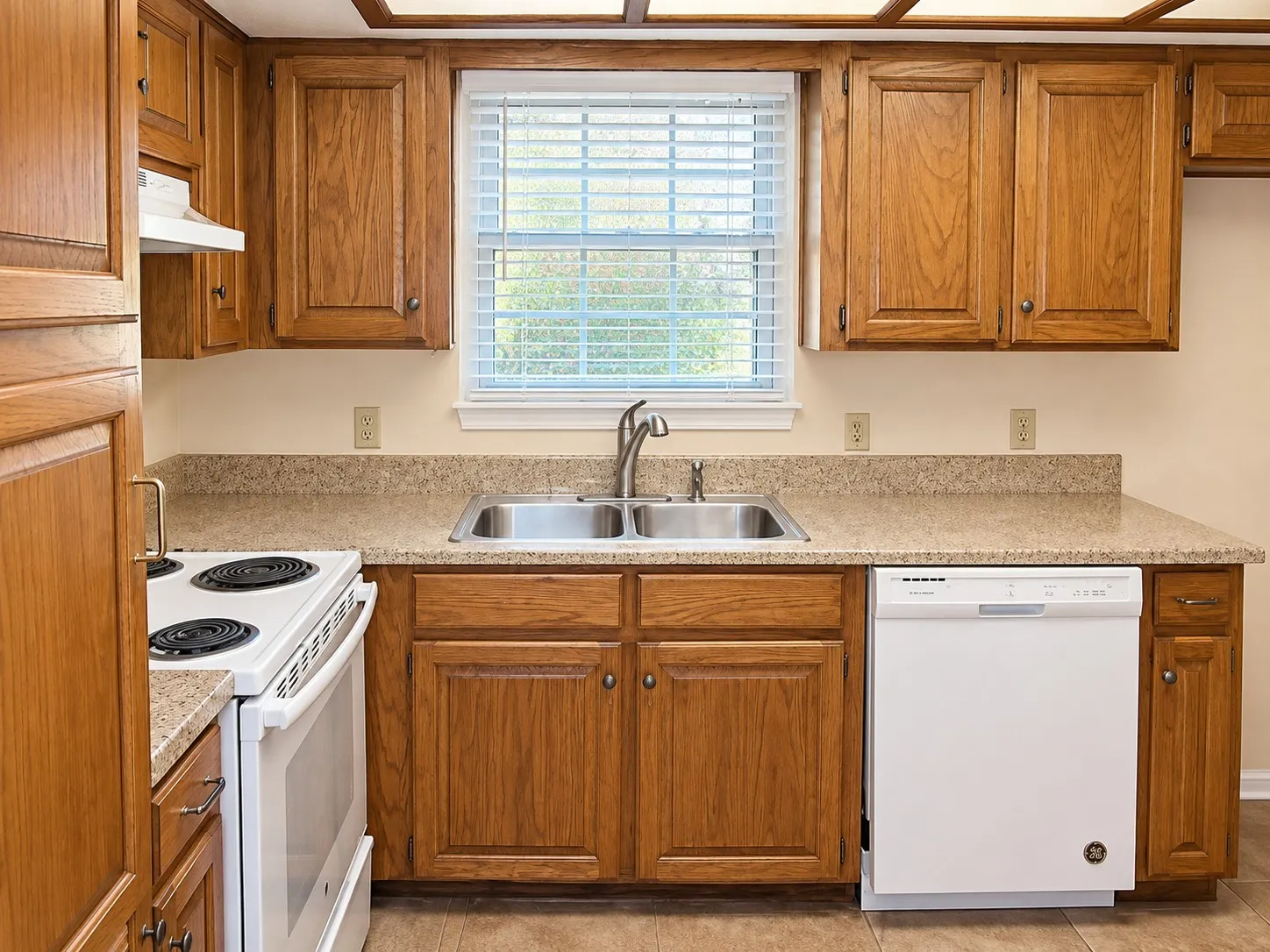203- Wood-finish cabinetry paired with a light-toned countertop