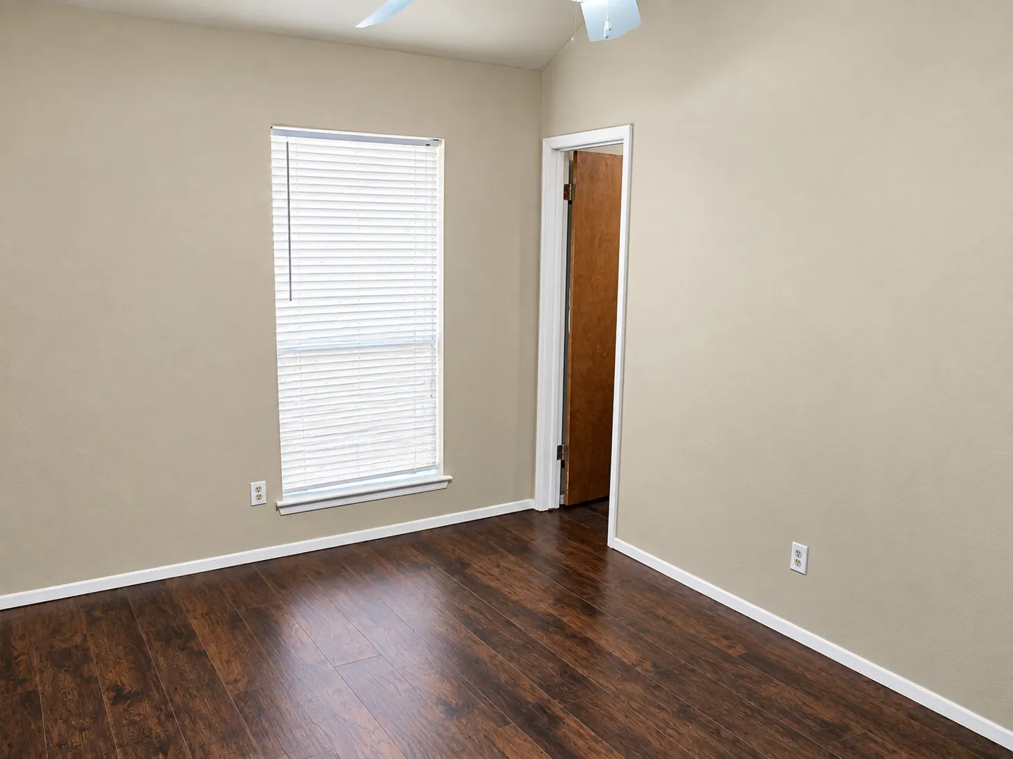 201- Wood-finish flooring with neutral wall tones, a window with blinds, and ceiling fan