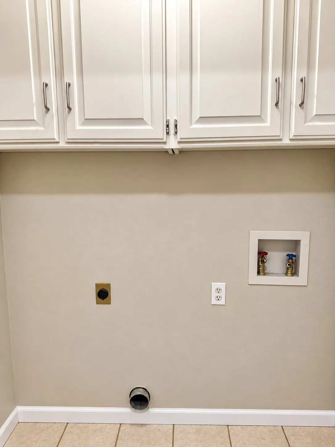 201- White shaker-style cabinetry with brushed nickel hardware, tile flooring, and utility hookups