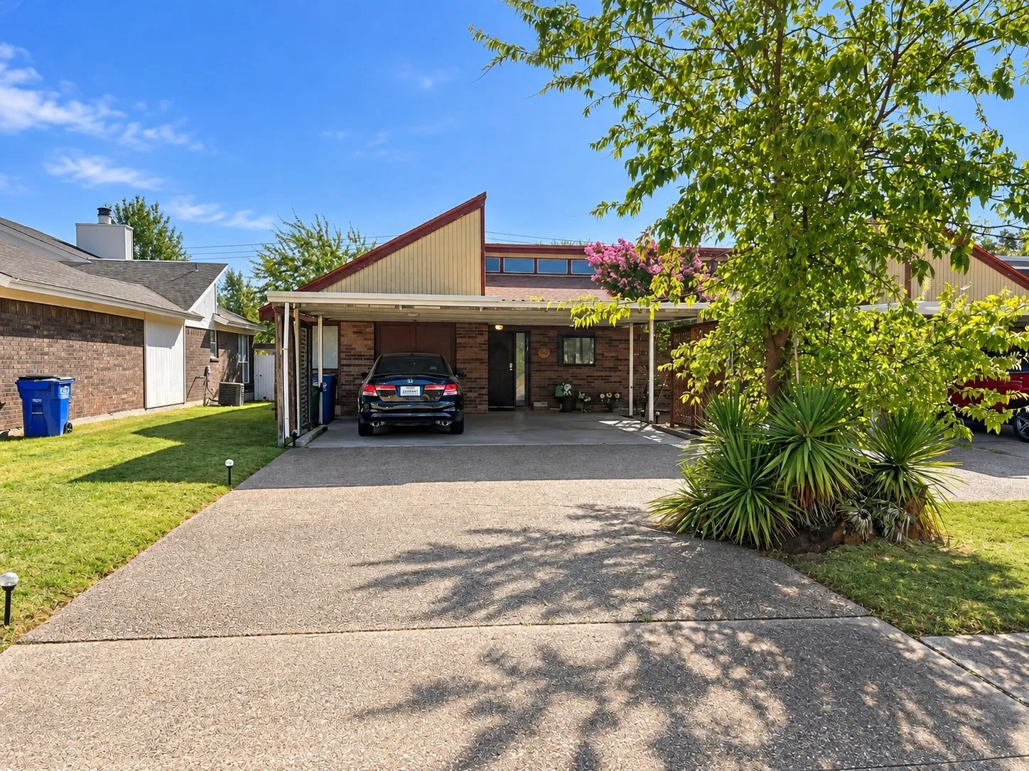 201 Yorkshire -
Brick facade with an angled roofline, covered carport, and a concrete driveway