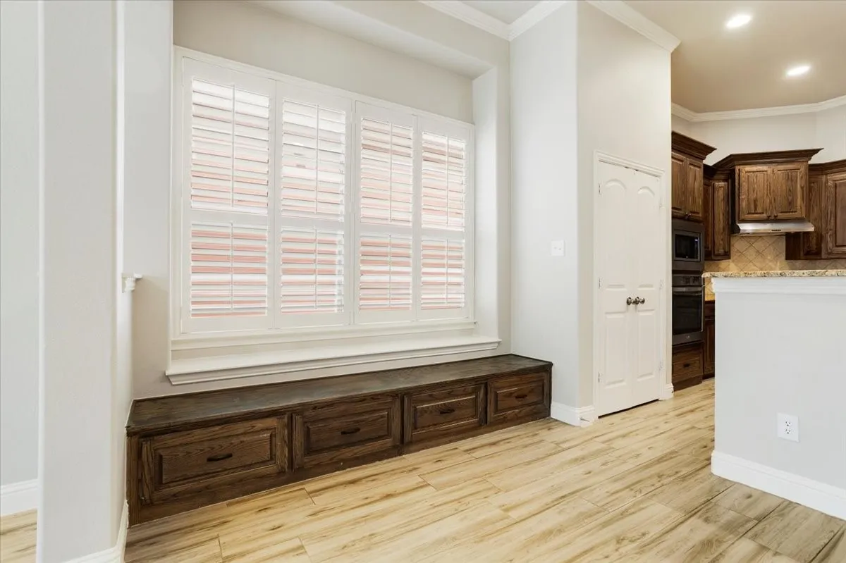 Built-in window bench with dark wood-finish drawers