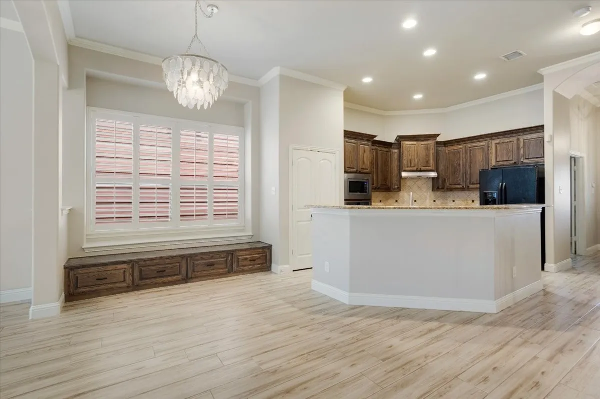 Open-concept living space with wood-finish flooring