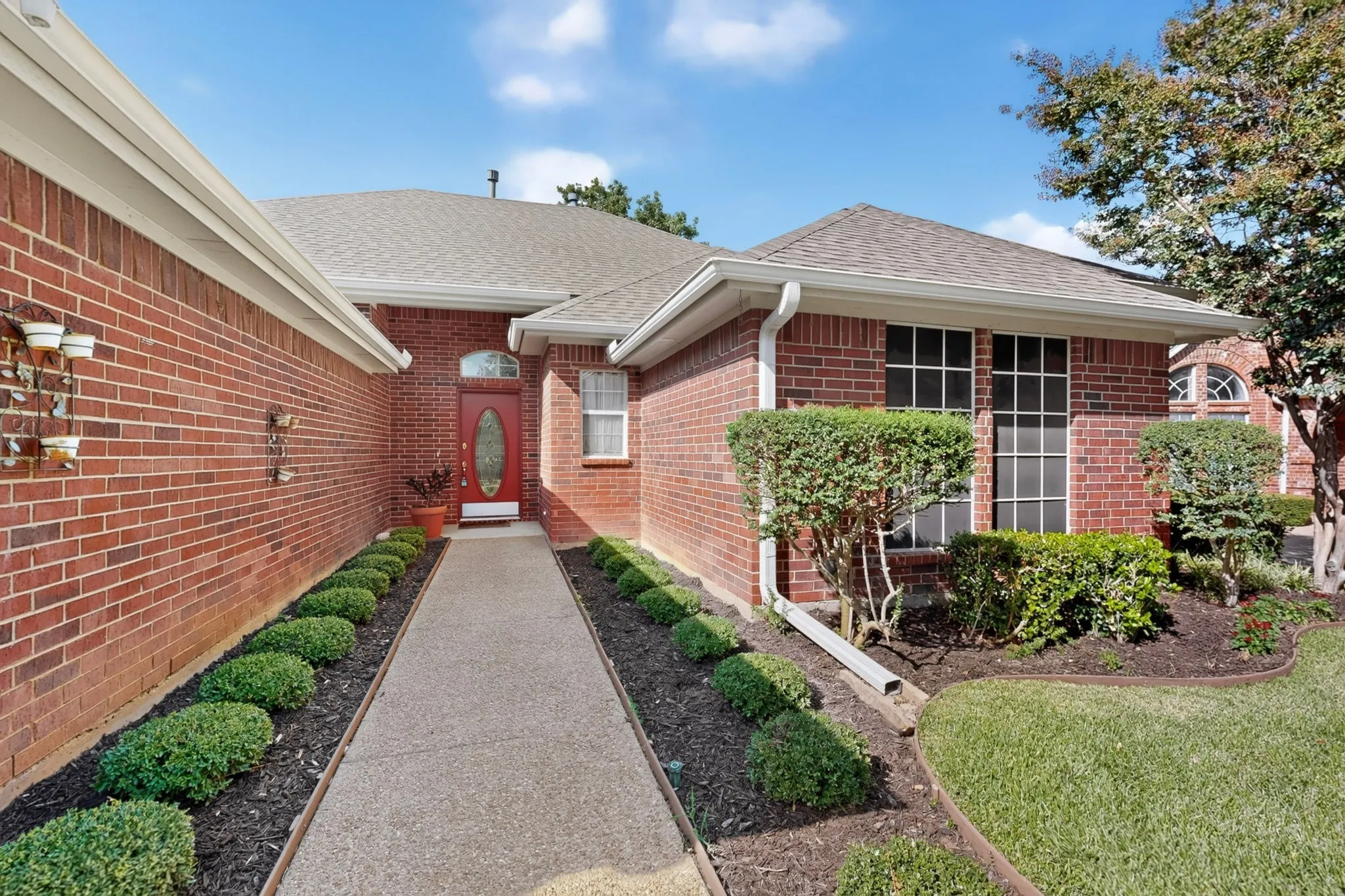 Brick exterior with a gabled roof and white gutters